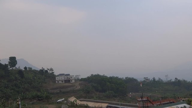 natural landscape at peak 2, bogor. many green hills and fresh air. visible from a distance cassava and vegetable fields.