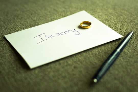 Marriage separation goodbye note with a wedding ring.