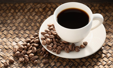 Black coffee in the cup,Espresso and bean on plate,Caffeine helps to be energetic