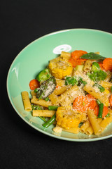 italian pasta salad, vegetables, mix leaves (tomato, onion, lettuce, chard, arugula and more) menu concept. food background. copy space. Top view