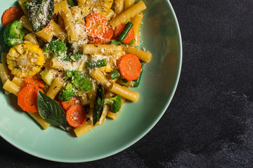 italian pasta salad, vegetables, mix leaves (tomato, onion, lettuce, chard, arugula and more) menu concept. food background. copy space. Top view