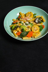 italian pasta salad, vegetables, mix leaves (tomato, onion, lettuce, chard, arugula and more) menu concept. food background. copy space. Top view