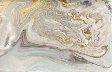 Gray marble pattern with golden glitter. Stone ripple texture.
