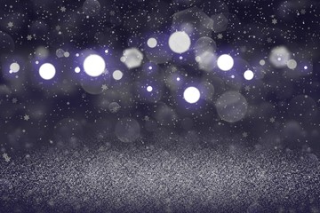 Fototapeta na wymiar blue wonderful brilliant glitter lights defocused bokeh abstract background with falling snow flakes fly, holiday mockup texture with blank space for your content