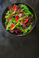 healthy salad figs, cheese, lettuce (arugula, spinach and other ingredients, snack, healthy food) menu concept. food background. copy space. Top view