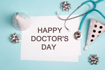 Doctor's day greeting card with stethoscope and festive caps.