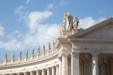 Fototapeta premium Statues on top of the Colossal Tuscan colonnades in Piazza San Pietro (St. Peter's Square) in Vatican City