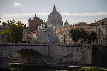 Fototapeta na wymiar Rome, Italy. Vatican dome of Saint Peter Basilica (Italian: San Pietro) and Sant'Angelo Bridge, over Tiber river.