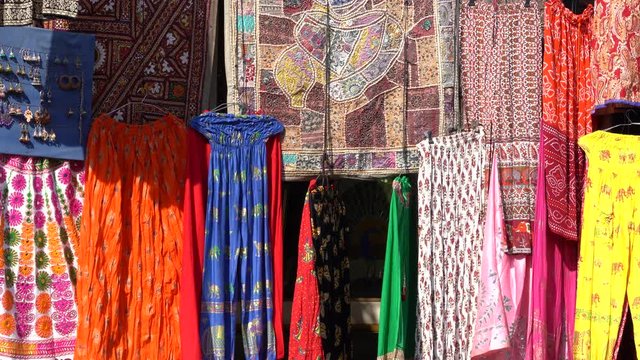Assortment of colorful clothes for sale in local street market in Udaipur, Rajasthan, India. Close up