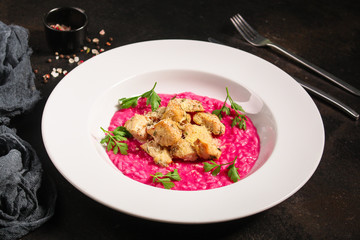 risotto chicken meat (red rice with beetroot flavor, delicious main course) menu concept. food background. copy space. Top view