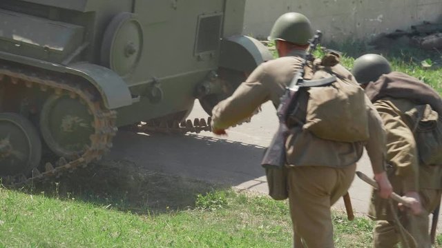 Two soldiers carry a machine gun Maxim