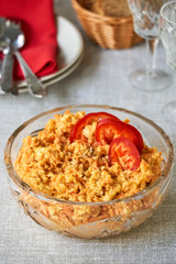 Rice salad with carrots and cheese in a glass bowl