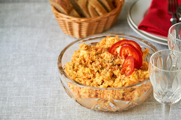 Rice salad with carrots and cheese in a glass bowl