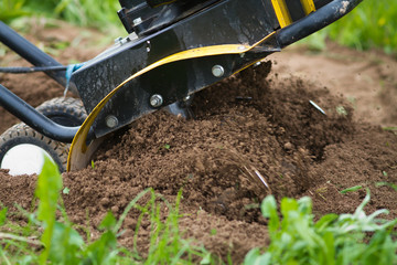 the cultivator tills the soil