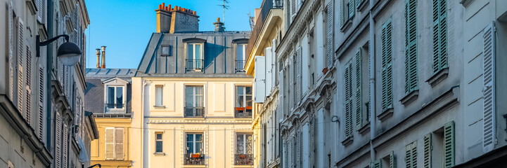 Paris, charming street and buildings, typical parisian facades in the Marais 