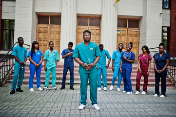 Naklejka premium Group of african medical students posed outdoor against university door.