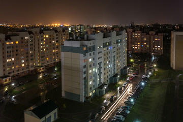 Obraz premium Night panorama of Light in the windows of a multistory building. life in a big city
