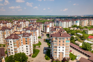 Naklejka na ściany i meble Top view of apartment or office tall buildings, parked cars, urban city landscape. Drone aerial photography.