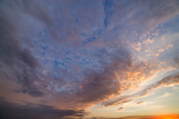 Dramatic sunset sky with orange clouds.