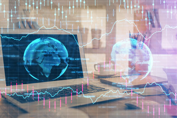 Financial graph colorful drawing and table with computer on background. Double exposure. Concept of international markets.