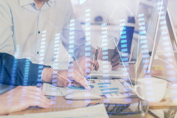 Multi exposure of chart with man typing on computer in office on background. Concept of hard work.