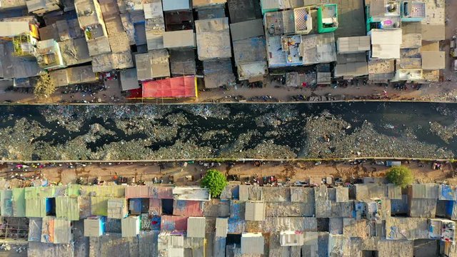 Aerial: Dirty drainage canal in slum - Mumbai, India