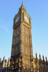 London big ben cock tower over sunny blue sky background,uk famous monument, travel destination 