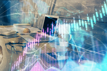 Financial chart drawing and table with computer on background. Multi exposure. Concept of international markets.