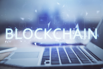 Multi exposure of blockchain theme hologram and table with computer background. Concept of bitcoin crypto currency.