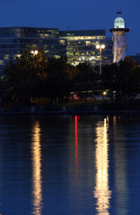Fototapeta na wymiar Lighthouse and office buildings at the Danube Island in Vienna Austria