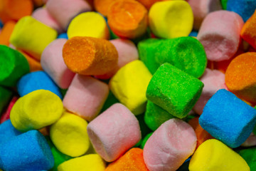 Close up of a huge pile of colorful marshmallows red, yellow, orange, green and blue. Colourful candy background