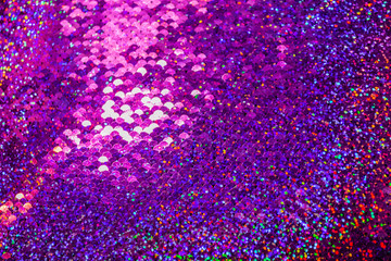 Lots of colorful sequins in pink colors sewn on fabric as scales. Beautiful shiny texture background - obrazy, fototapety, plakaty