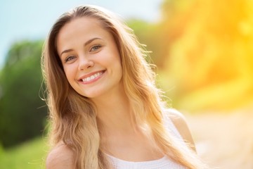 Young woman on field under sunset light