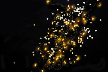 Festive background with gold sparkles and garland. Holiday Party concept