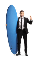 Businessman showing thumbs up and holding a surfing board