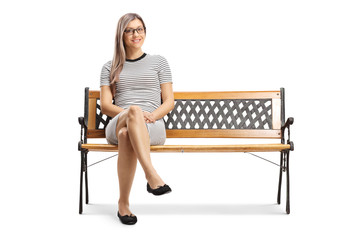 Young blond woman sitting on a bench