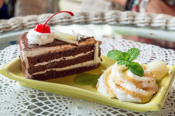 Fresh mint and chocolate cake on plate, close up