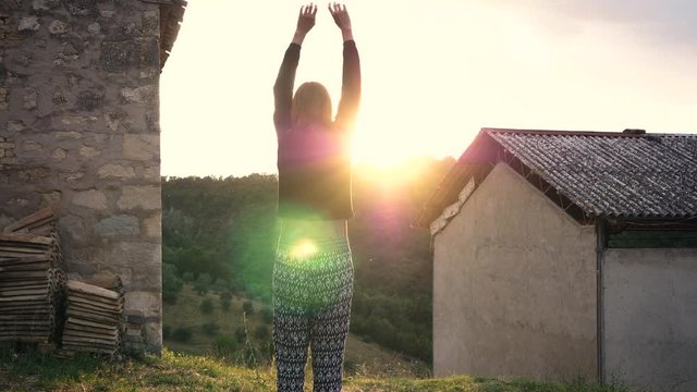 Girl doing yoga exercise in Italian sunset