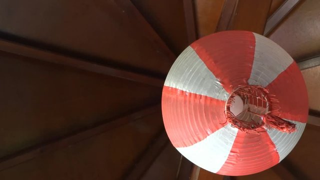 red and white lanterns hanging on a wooden roof. The photo was taken while I was in a Chinese restaurant