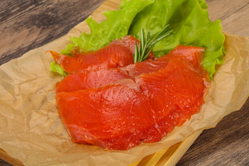 Sliced salmon fillet served rosemary
