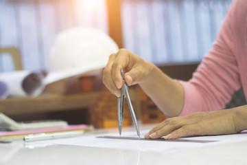 Business women are sitting writing future office building projects.