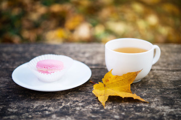 cup of tea on wooden surface with autumn atmosphere