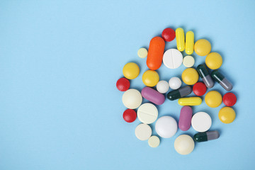 Medical background formed with different bright pills with copy space