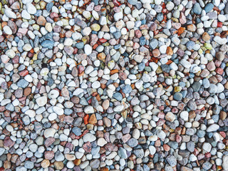 Natural background with stones on beach. Colorful stones on seaside.