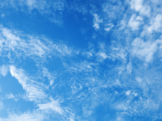 Cloudscape on blue sky. Clouds of different shapes on blue sky background.