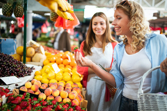 Beautiful happy women shopping vegetables and fruits