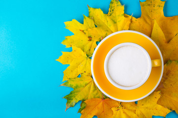 yellow cup with croissant on a blue background