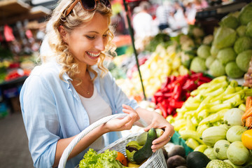 Young woman shopping healthy food on the market