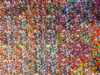 Fototapeta na wymiar Bright rainbow colored background. Shiny and sparkling holographic backdrop. Top view, flat lay.
