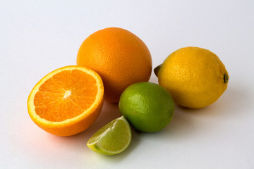 Fresh oranges and lemons isolated on white background